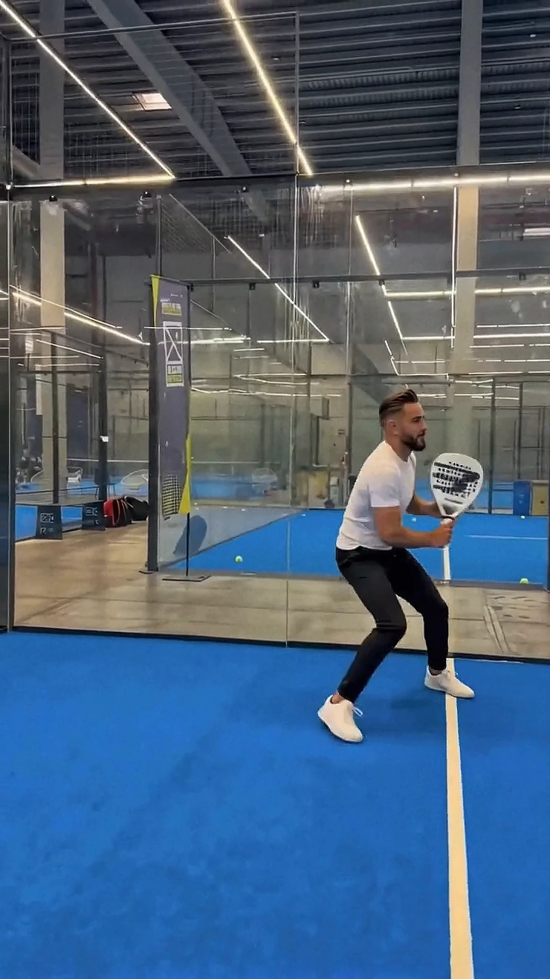 David playing padel on an indoor court